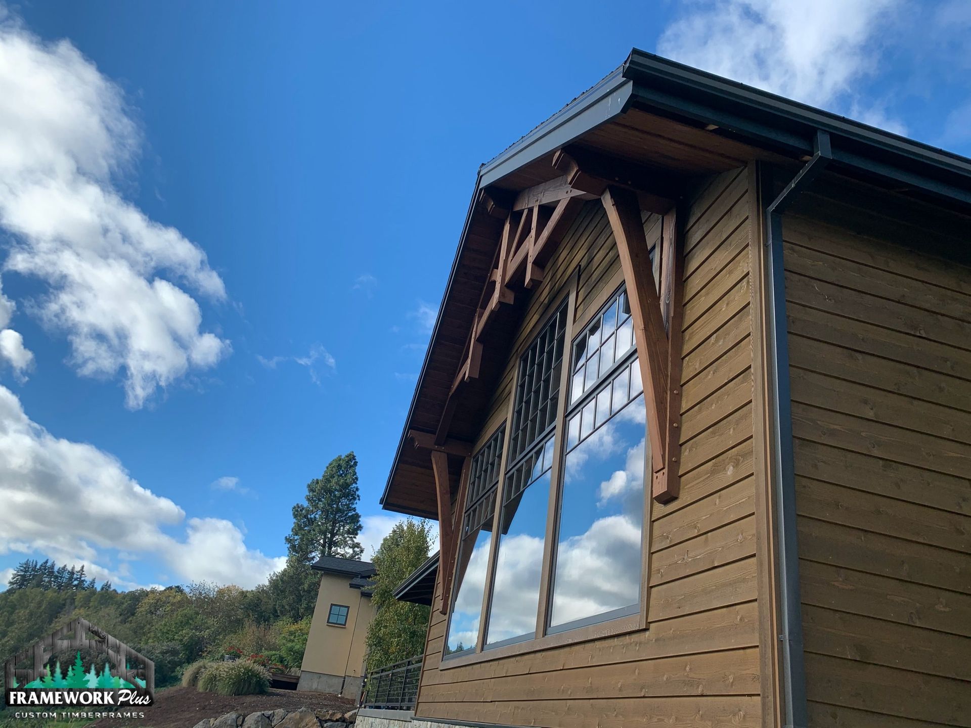 A house with a lot of windows and a blue sky in the background