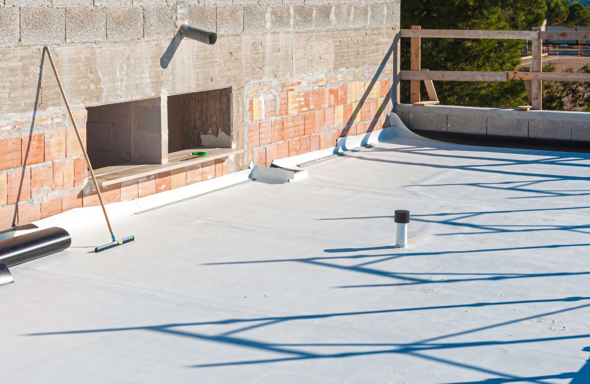 Single-ply flat roof installation by professional commercial roofing services on a modern building.