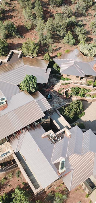 Aerial view of buildings with angled roofs in a natural setting.