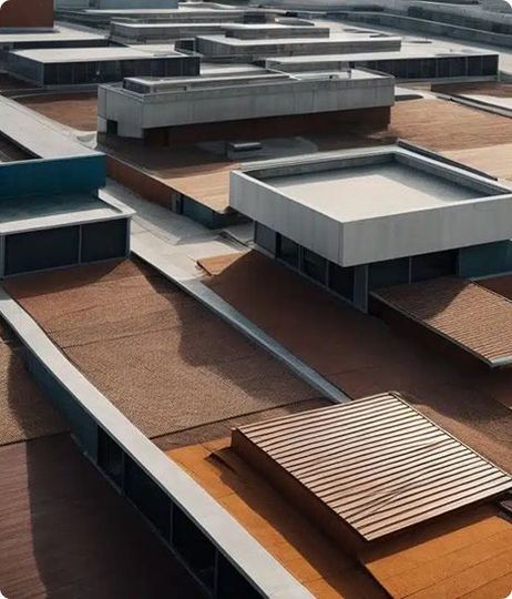 Overhead view of a modern building rooftop with varying levels and rectangular structures; brown and gray tones.