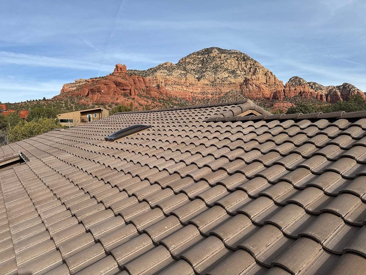 Brown tile roof with a red rock mountain backdrop.