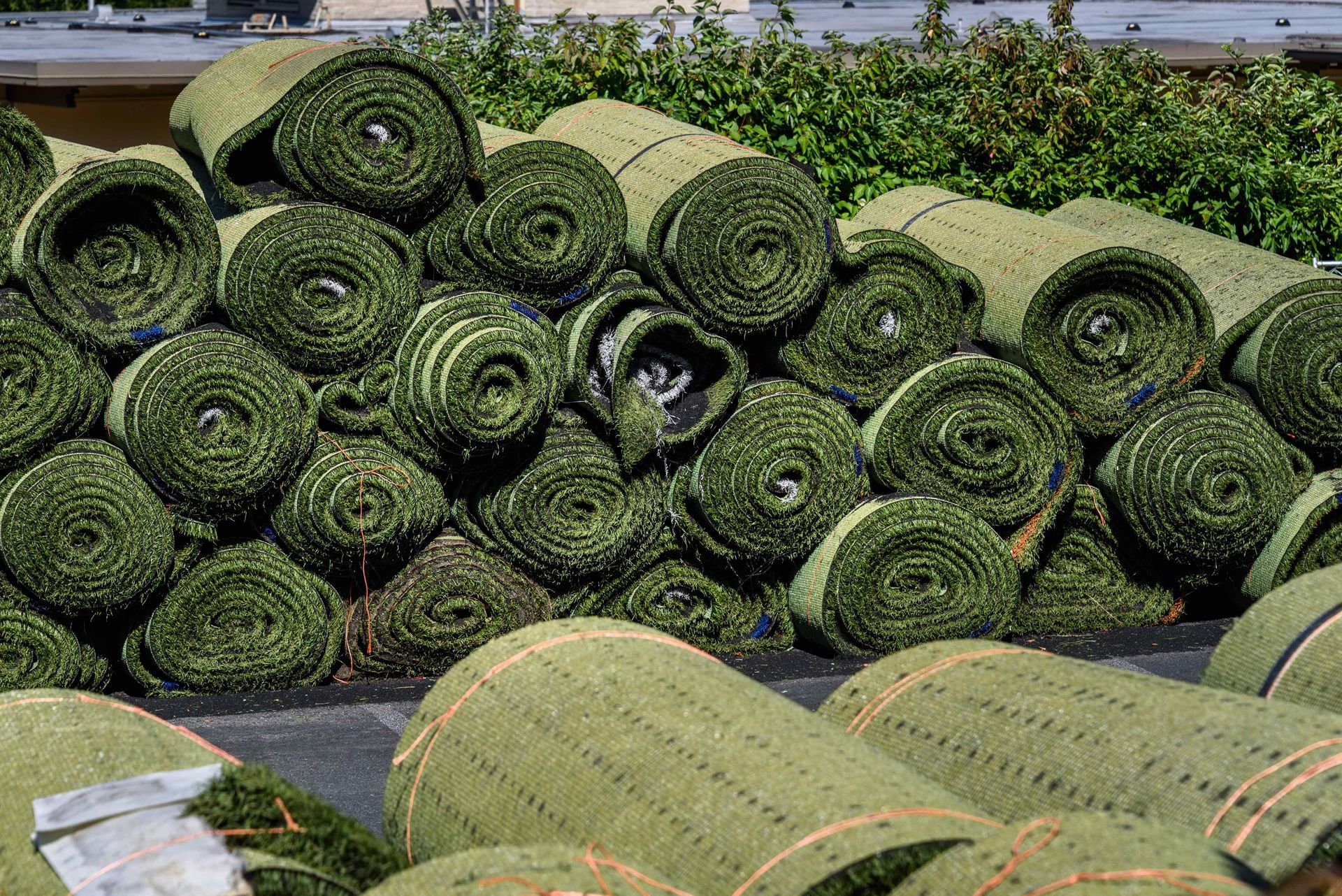 Endless supply of artificial turf rolls ready for installation