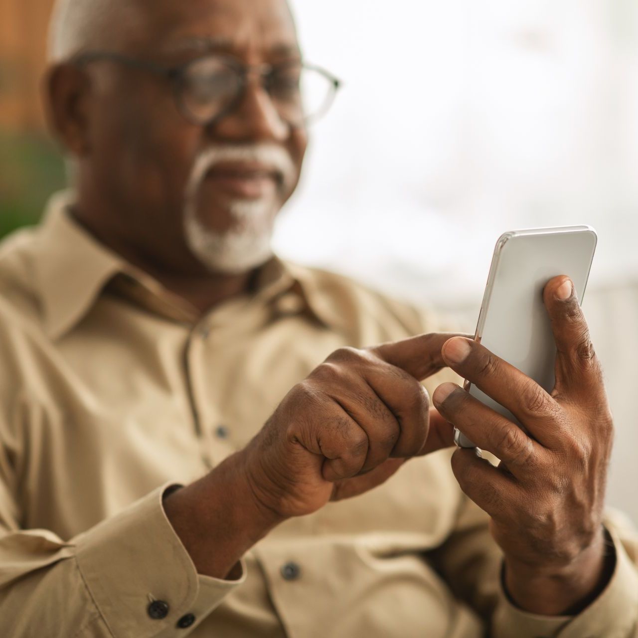 an elderly woman is holding a cell phone in her hand