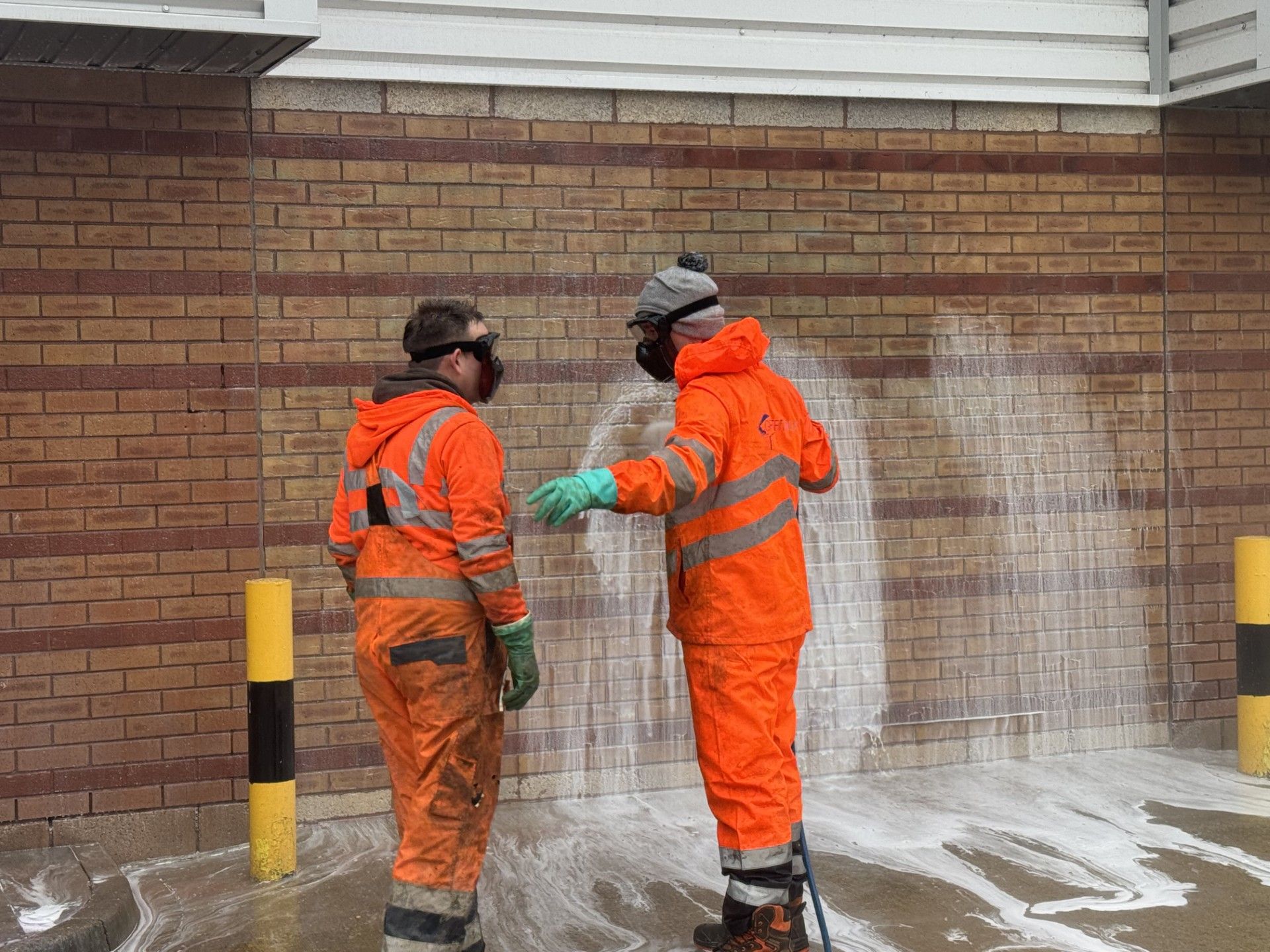 Graffiti removal from the sides of bridge wall