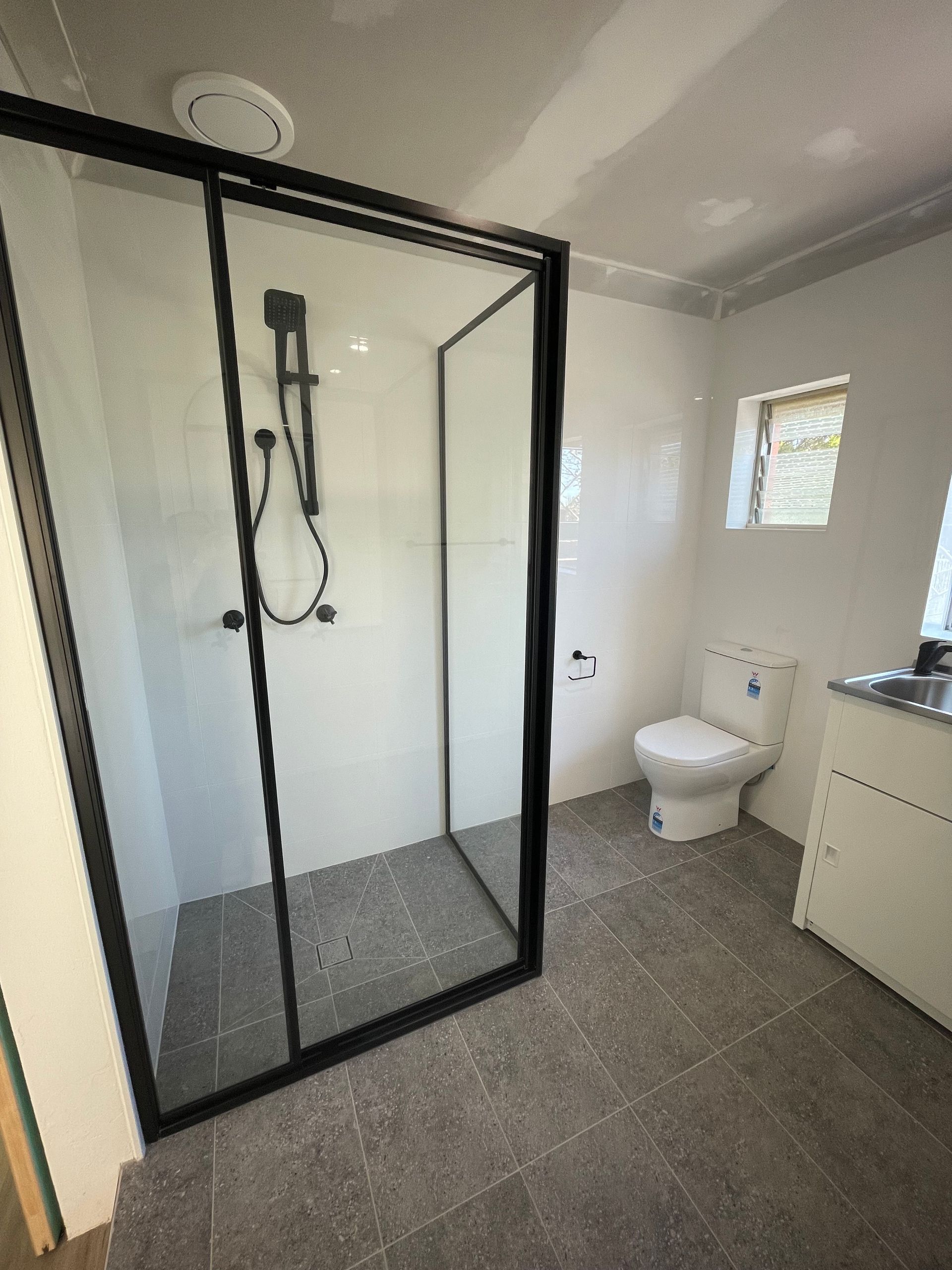 Copper Pipes Installed Against a Tiled Wall, With Various Valves and Fittings — B & A Plumbing & Gas In Wauchope, NSW