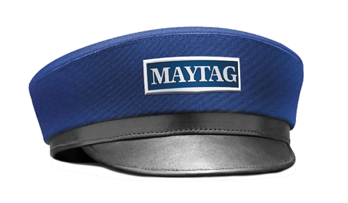 A man with a backpack is standing next to a lake in the woods.