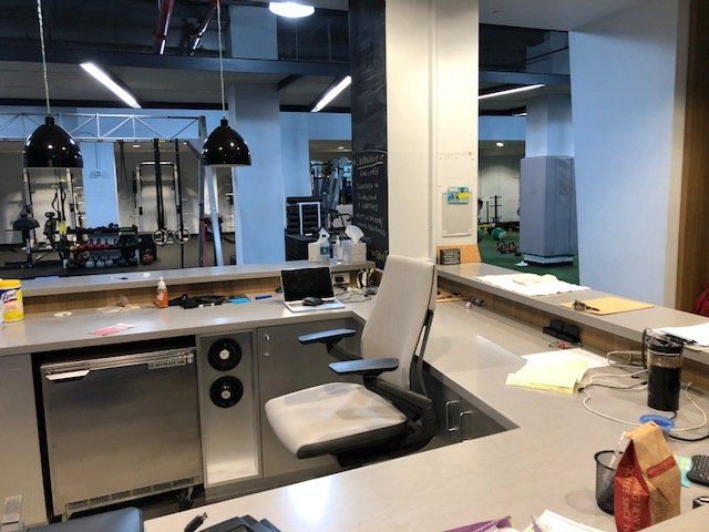 Therapy desk and administrative workstation inside the Park Avenue clinic reception and rehab area.
