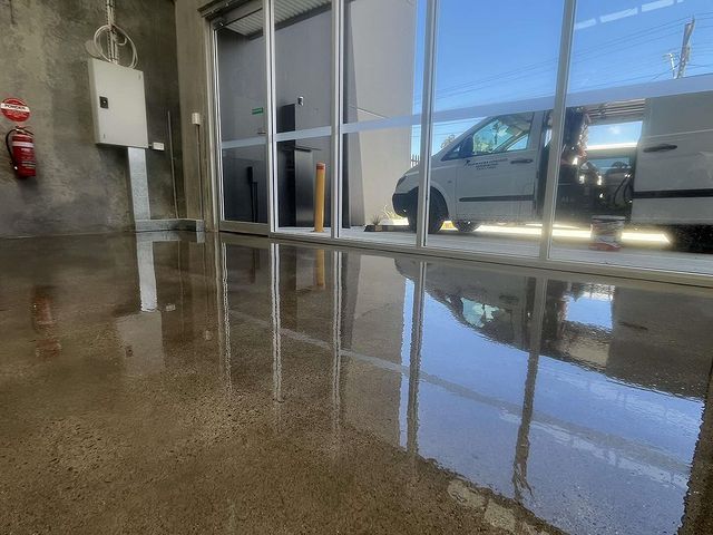 A White Van Is Parked in A Garage Next to A Window — Illawarra Resurfacing Pty Ltd in Balgownie, NSW