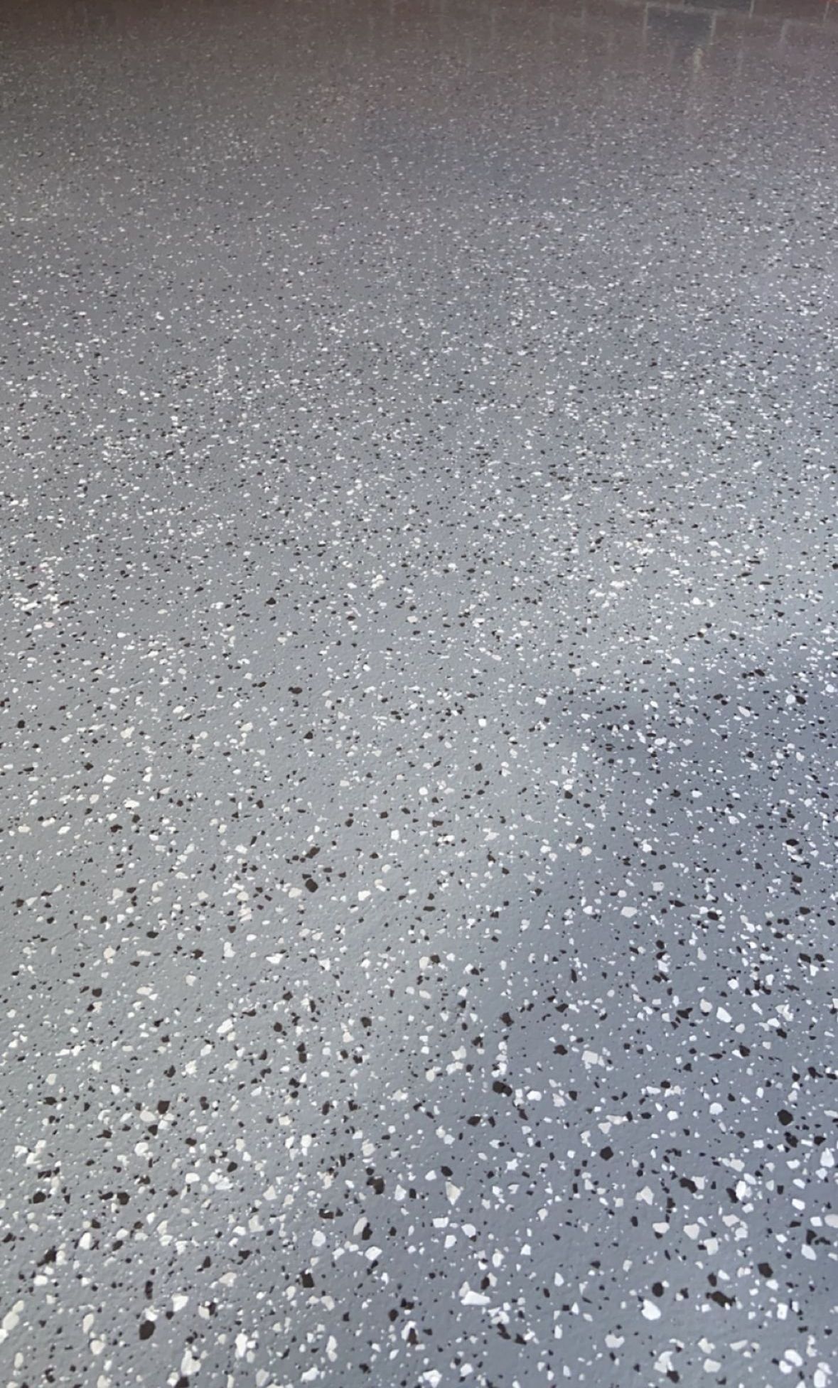 An Epoxy Driveway Leading to A House with A Garage — Illawarra Resurfacing Pty Ltd in Balgownie, NSW