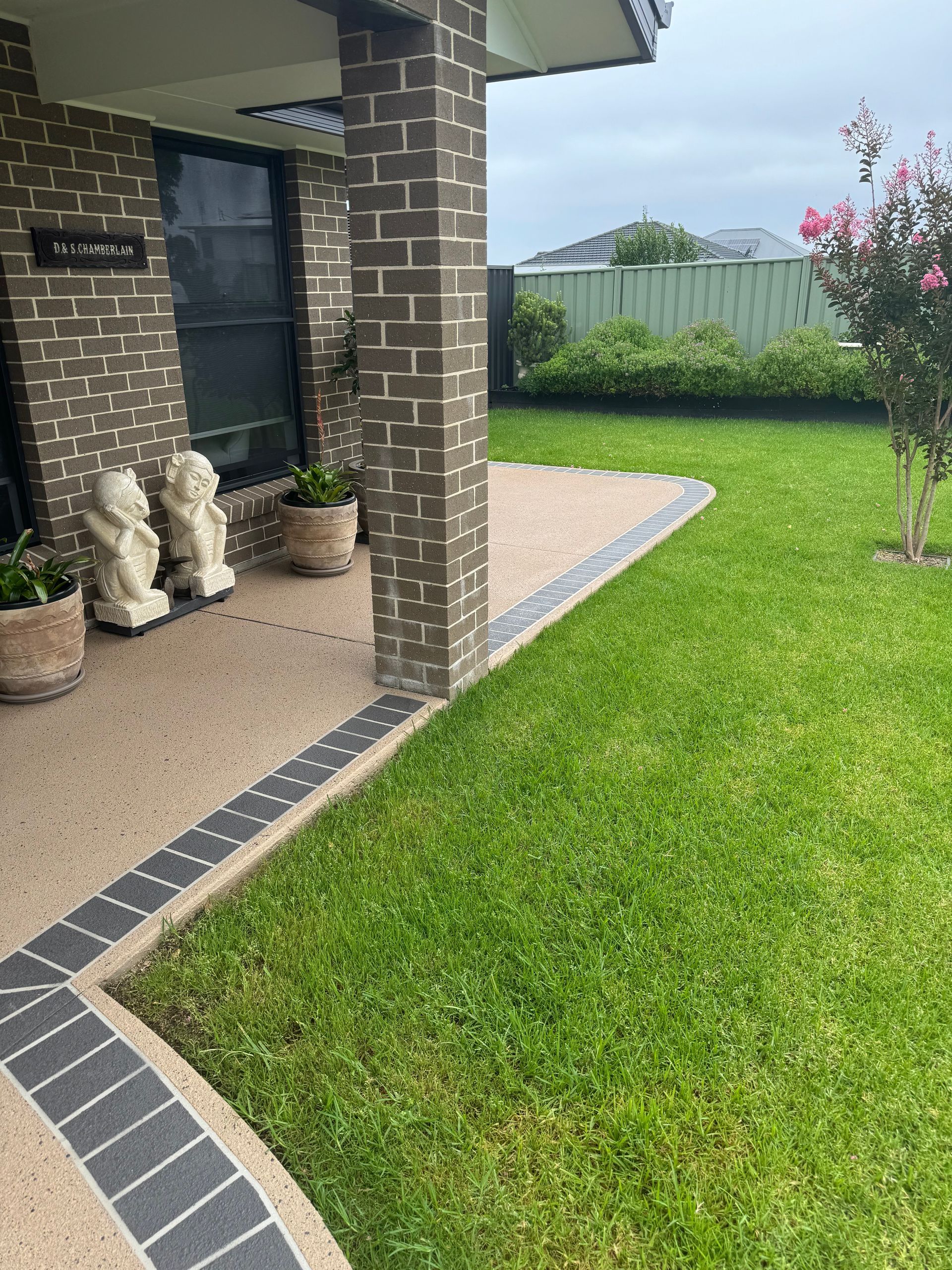 A White Suv Is Parked in A Driveway Next to A House — Illawarra Resurfacing Pty Ltd in Balgownie, NSW