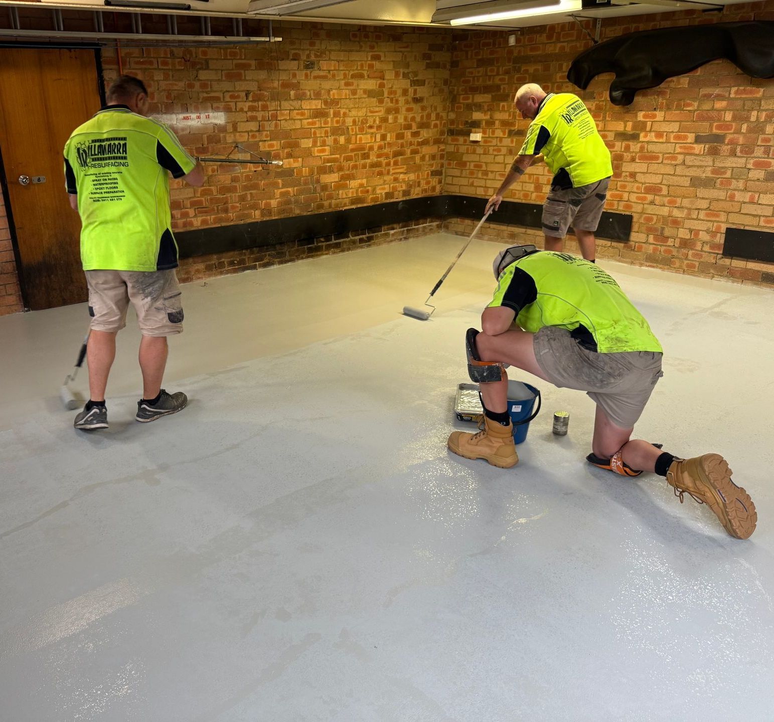 A Driveway with A Garage Door and A Fence in The Background — Illawarra Resurfacing Pty Ltd in Balgownie, NSW