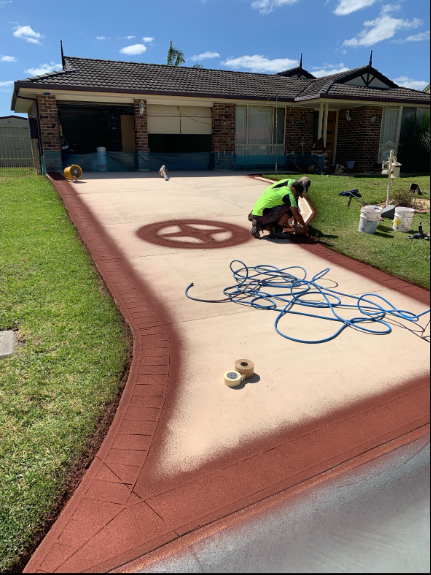 A Person Is Standing on A Roof with A Torch — Illawarra Resurfacing Pty Ltd in Shellharbour, NSW