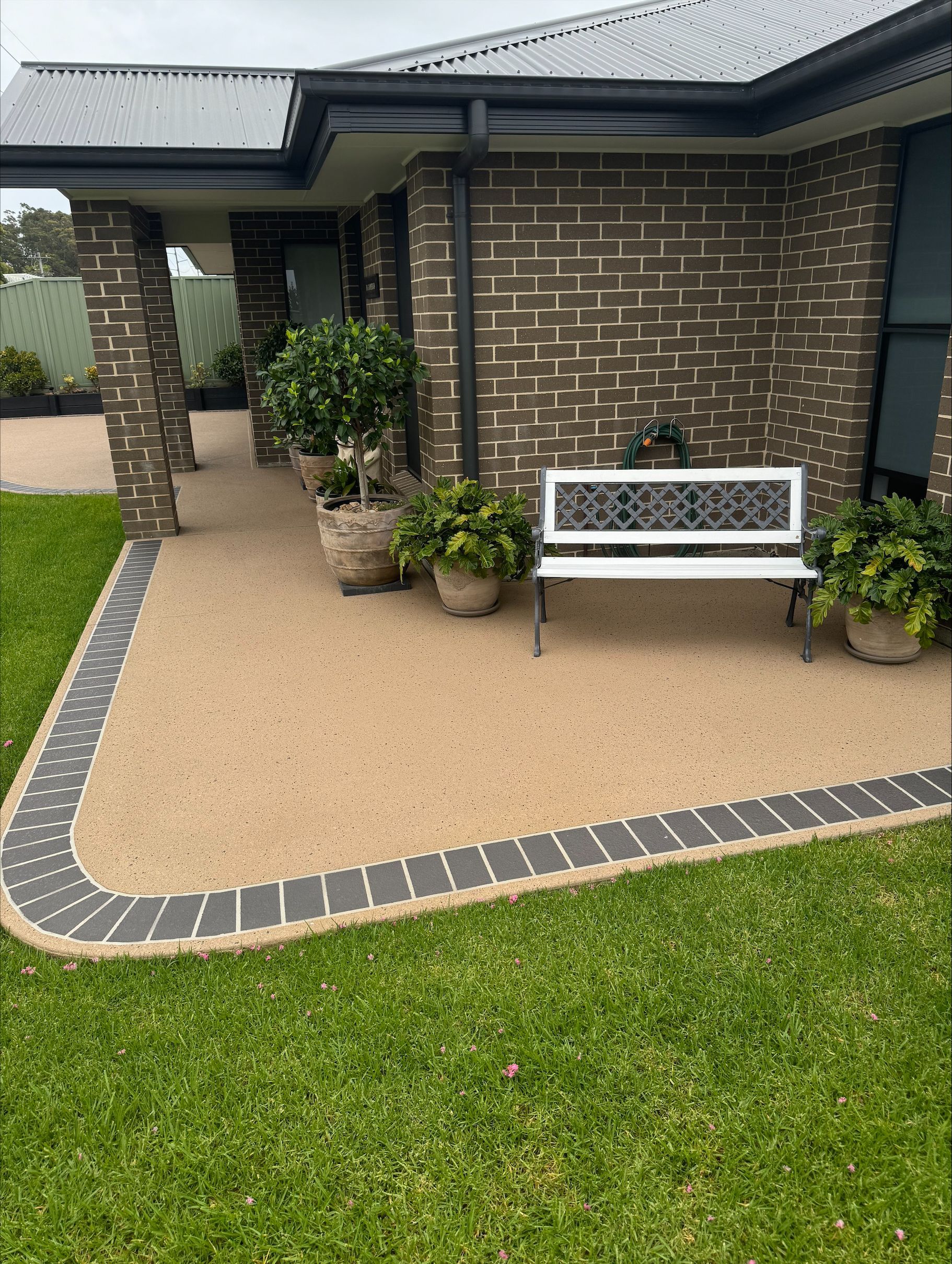 A White Bench In Front of House — Illawarra Resurfacing Pty Ltd in Balgownie, NSW