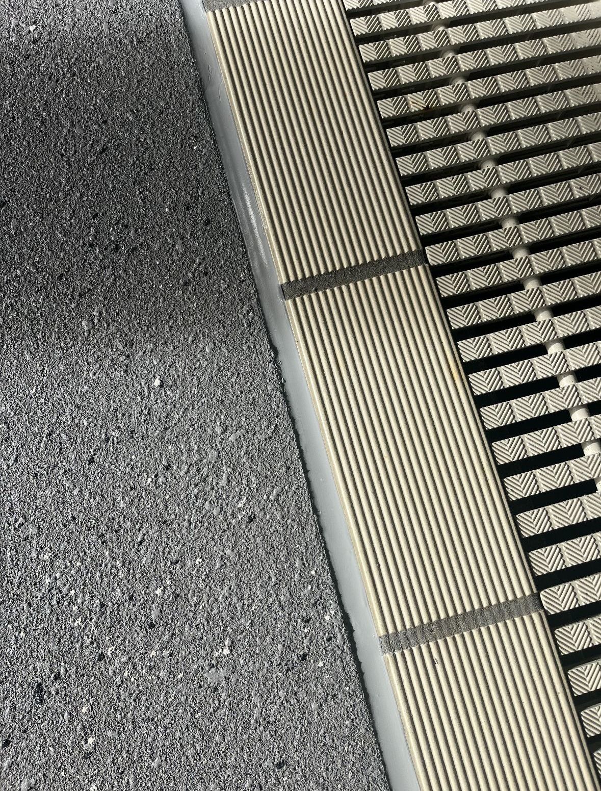 A Concrete Driveway Leading to A Door with Stairs on the side — Illawarra Resurfacing Pty Ltd in Balgownie, NSW