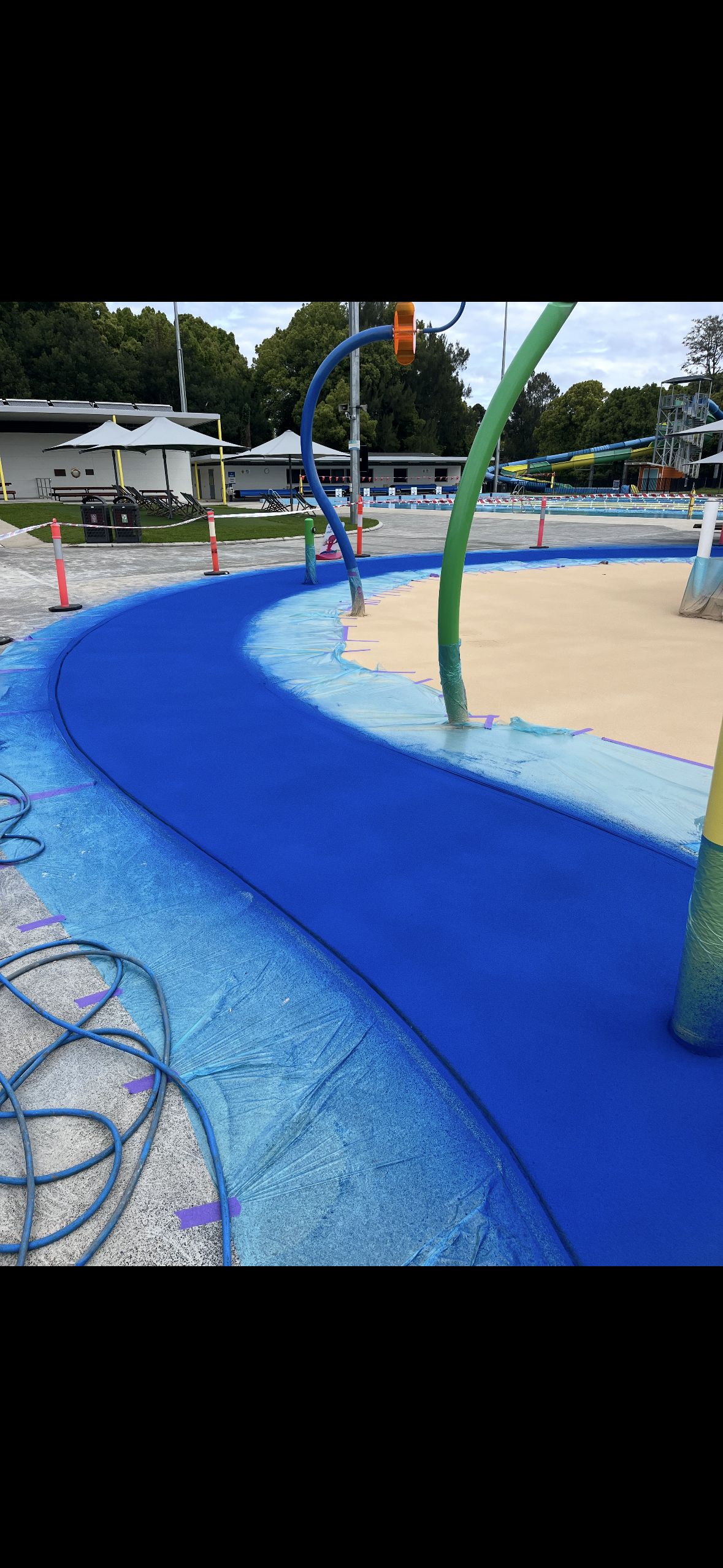 A Balcony with A View of The Ocean and A House with Solar Panels on The Roof — Illawarra Resurfacing Pty Ltd in Balgownie, NSW