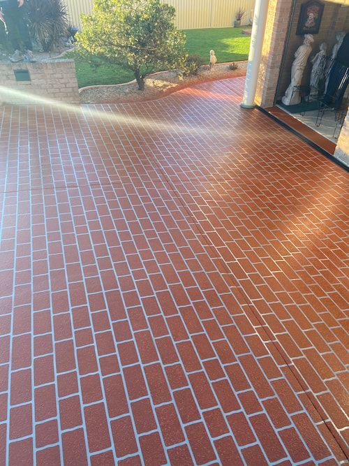 A Red Brick Floor with White Lines on It — Illawarra Resurfacing Pty Ltd in Balgownie, NSW