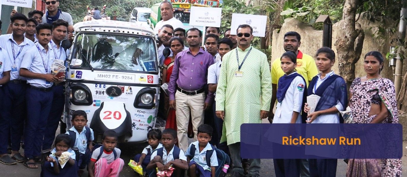 A group of people are posing for a picture in front of a rickshaw.