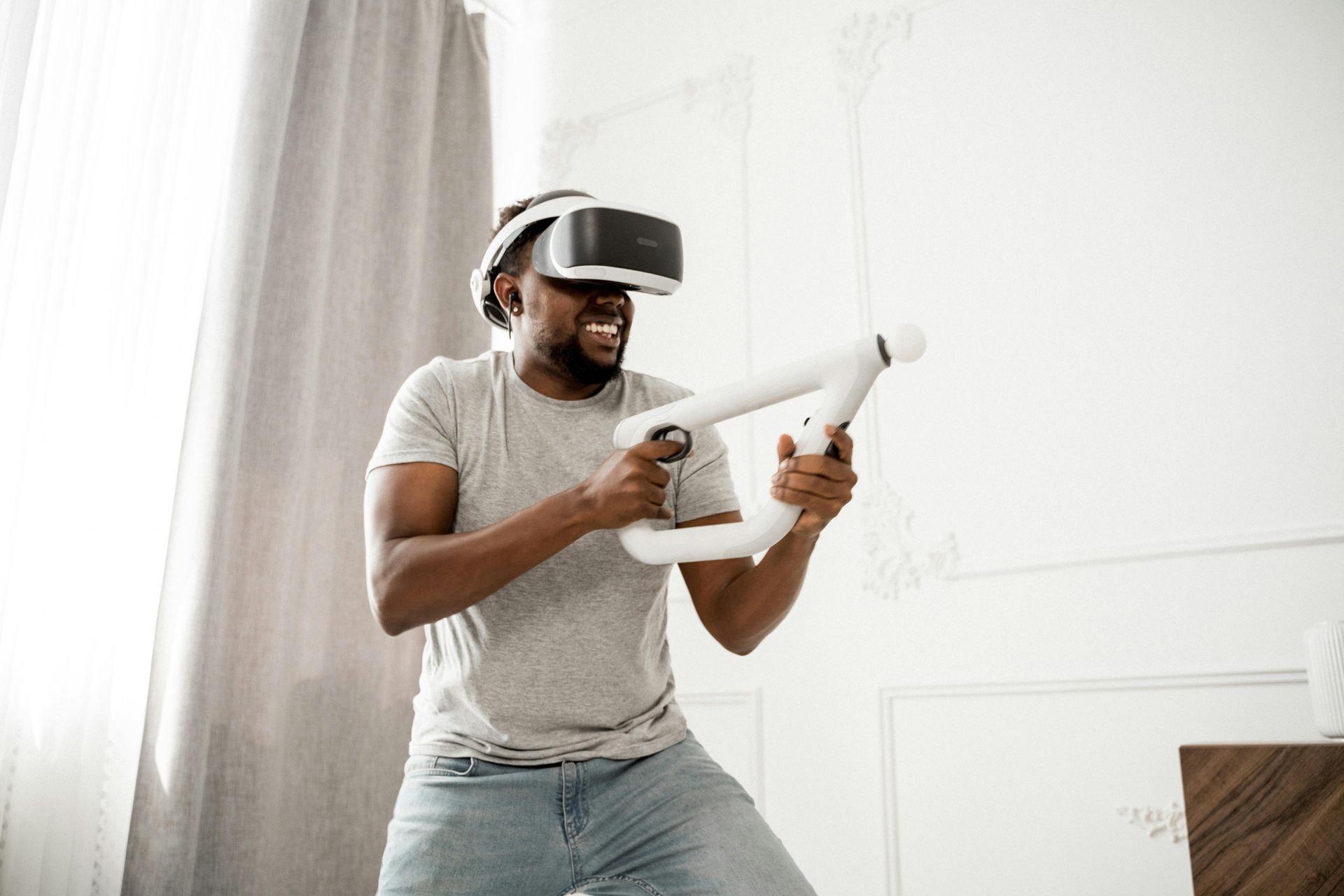 A man wearing a VR headset playing VR games. 