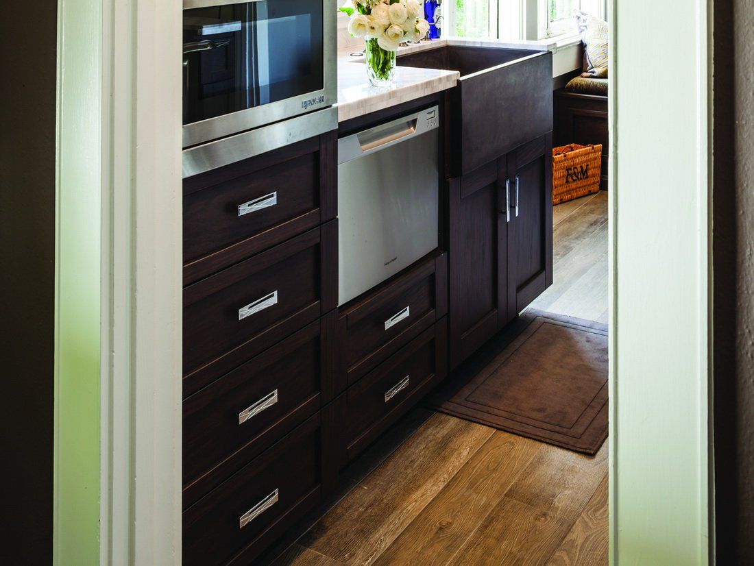 Kitchen with browns cabinets and silver hardware