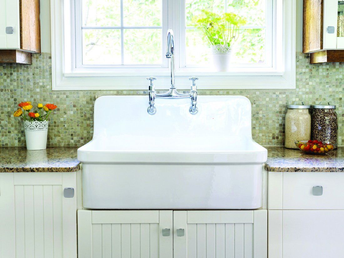 kitchen sink featuring white cabinets with silver hardware