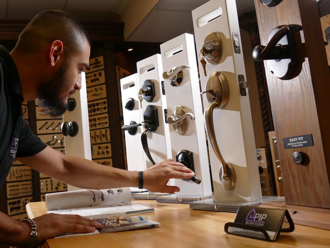 Worker Tests the Store's Door Hardware