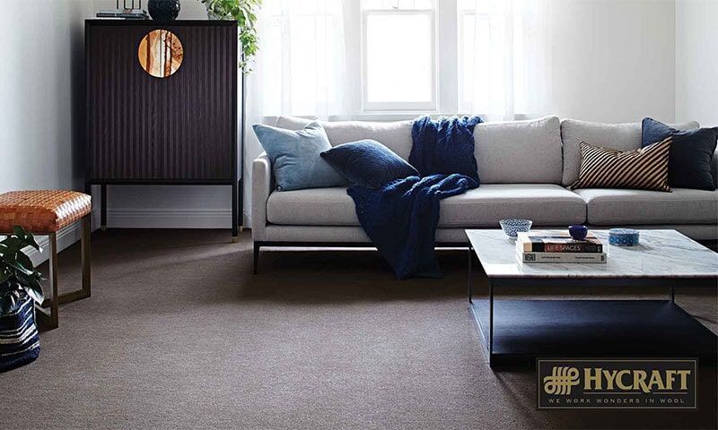 A Carpeted Living Room With a Couch and a Coffee Table — Floor Zone Gympie In Gympie, QLD