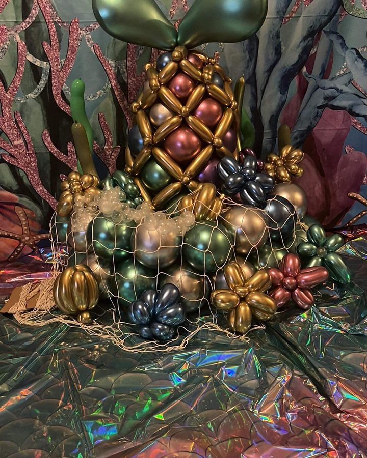 A pineapple made out of balloons is sitting on a table.