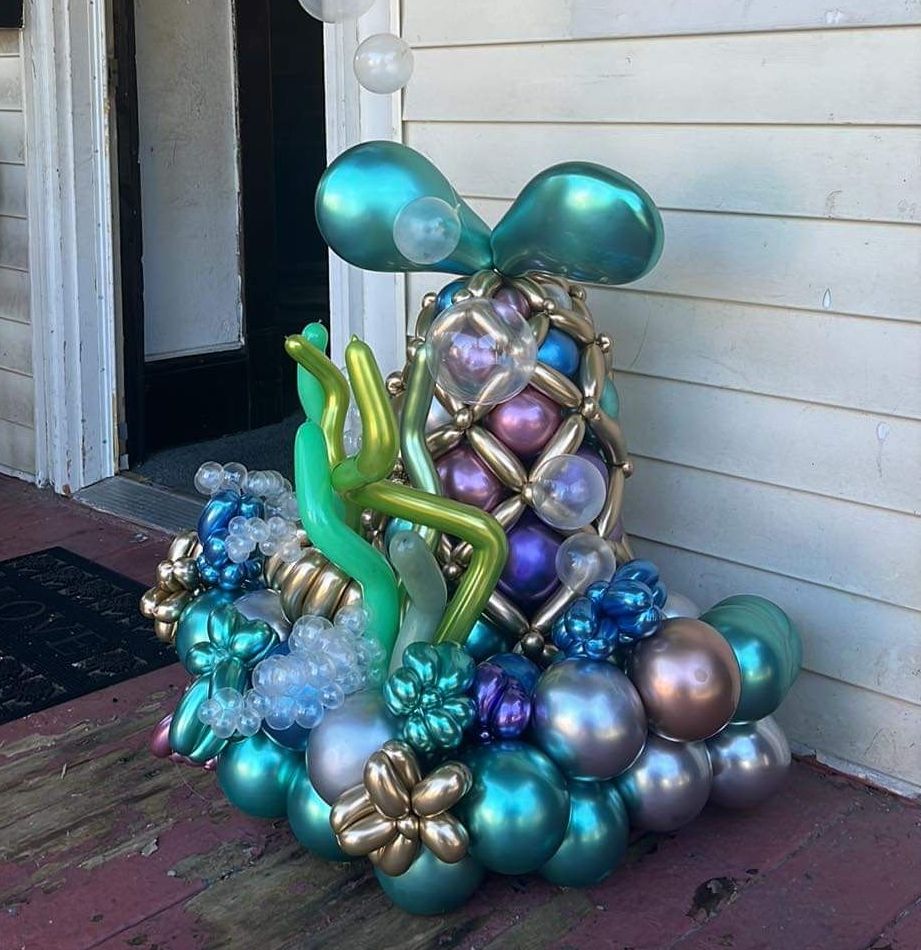 A bunch of balloons are sitting on a wooden floor