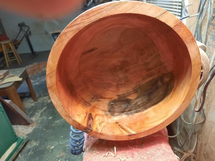 Wooden bowl, partially finished, inside view, showing wood grain and dark stain.