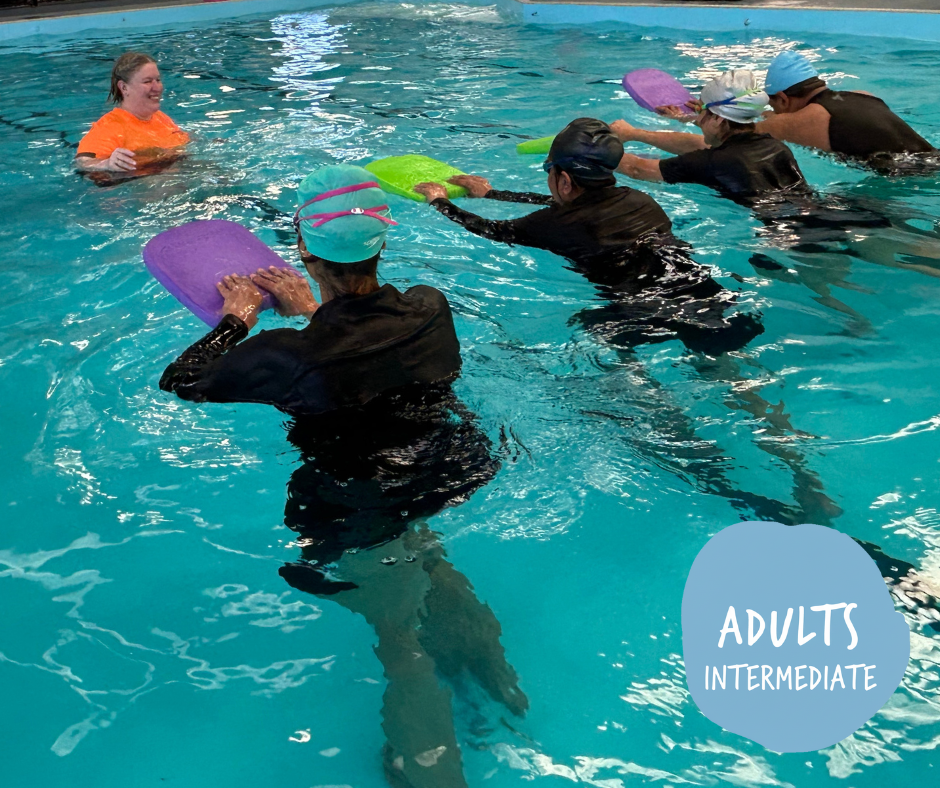 Woman snorkeling underwater, wearing mask and snorkel, arms outstretched, in blue water.