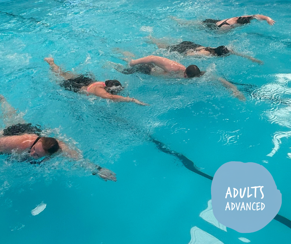 Boy swimming in a pool, holding a kickboard, water splashing, smiling.