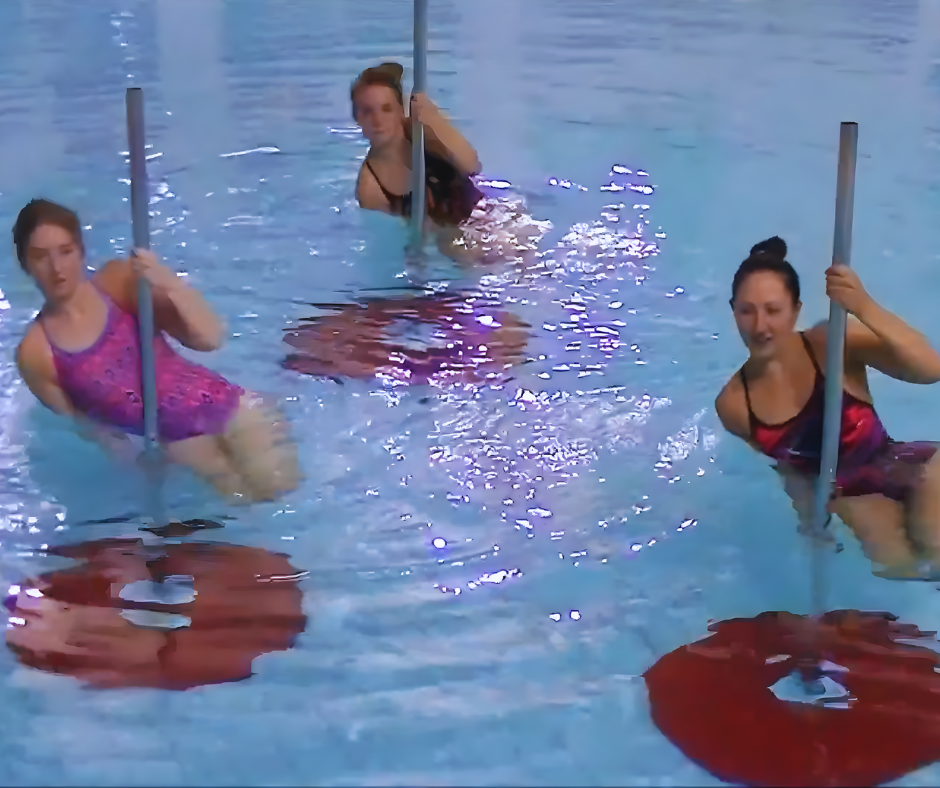 Boy swimming in a pool, holding a kickboard, water splashing, smiling.