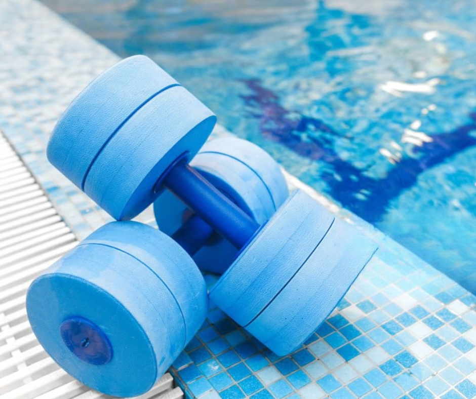Woman snorkeling underwater, wearing mask and snorkel, arms outstretched, in blue water.