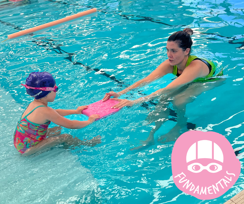 Boy swimming in a pool, wearing goggles and holding a kickboard, splashing.