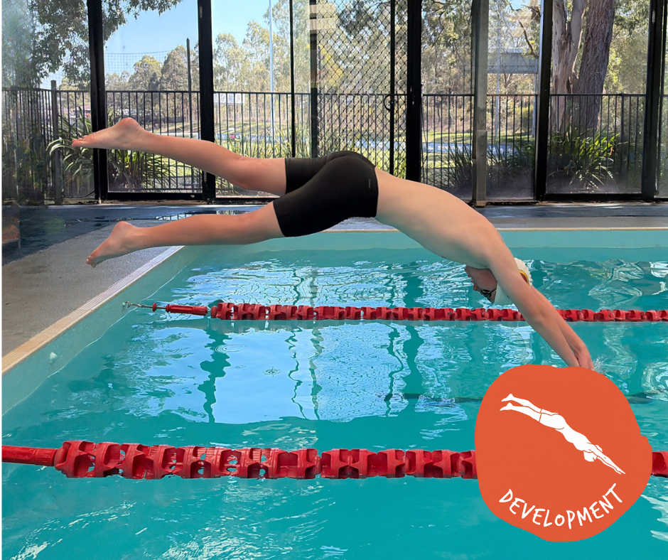 Swimmer in a white cap and goggles, performing the freestyle stroke in a pool.