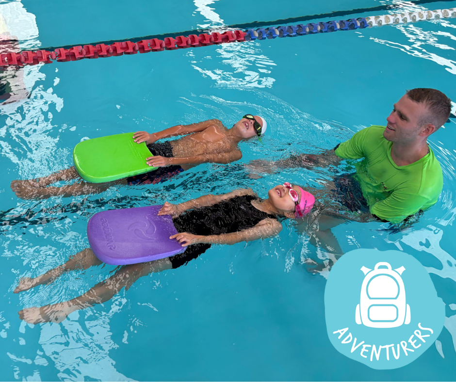 Woman in green shirt assists children swimming with a noodle in a pool.