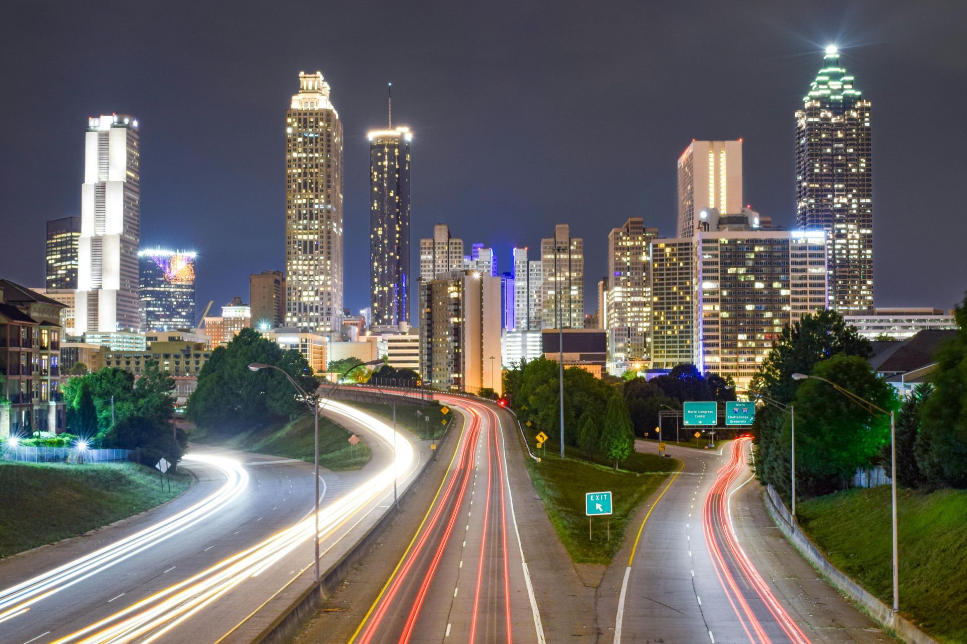 A highway that is going through a city at night