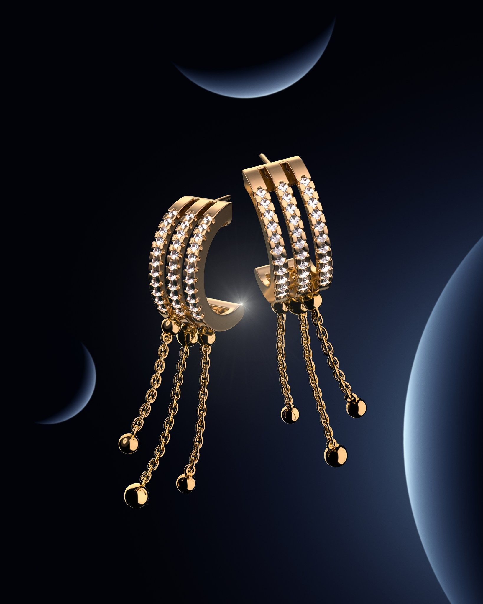 Boucles d'oreilles créoles en or avec chaînes pendantes et pierres précieuses scintillantes sur un fond sombre avec des formes en croissant.