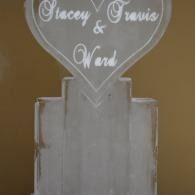 White heart-shaped sign reading “Stacey & Travis” above a frosted glass panel.