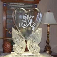 Decorative monogrammed heart and butterfly sculpture on a table in a living room
