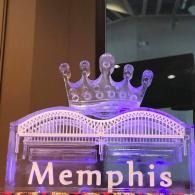 Purple-lit Memphis sign with a crown on top indoors