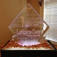 Clear ice sculpture with UNCF and LeMoyne-Owen College logos in a window-lit room