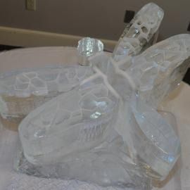 Ice sculpted dragonfly sitting as a focal point on a table