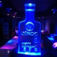 Glowing blue Cîroc bottle display with “Happy Birthday” text in a dark party setting