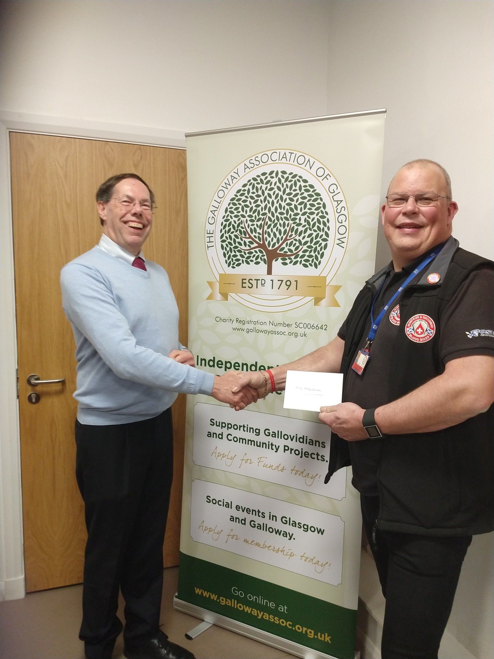President Angus Rex handing cheque to Dave Hook, Chairman of D&G Blood Bikes