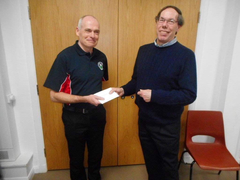 President Angus Rex handing cheque to David Tyson, Galloway Mountain Rescue Team