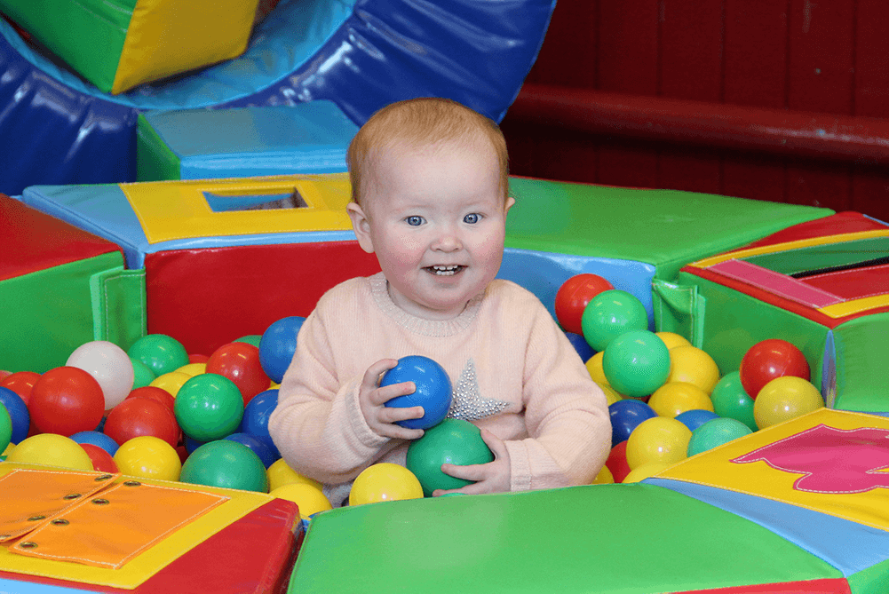 image of a baby in a ball pool project by the gallaway association of glasgow