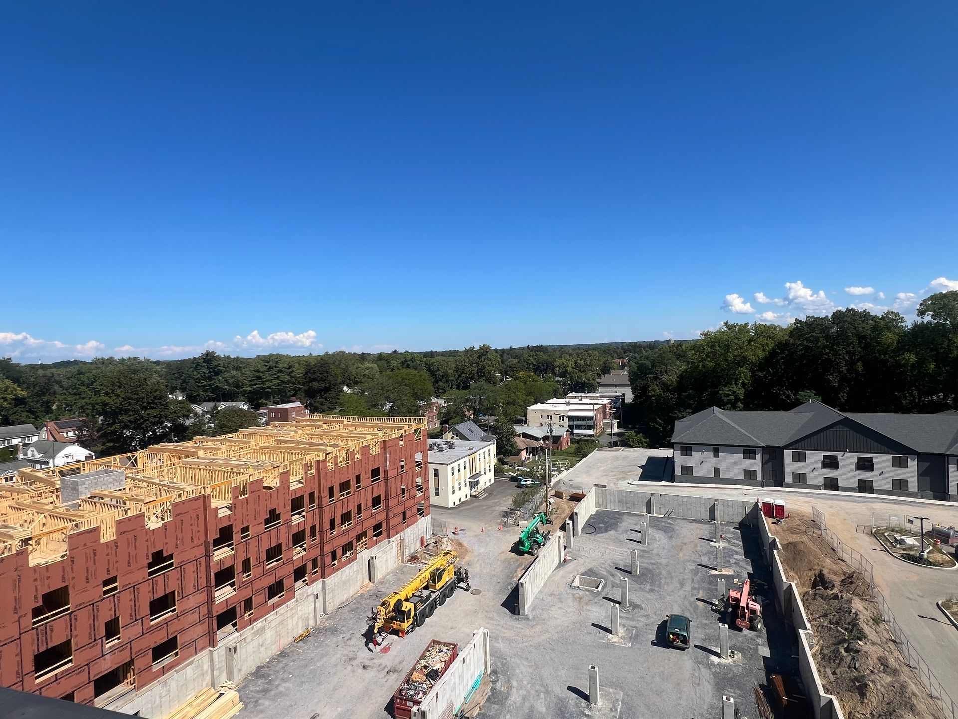 Interior under construction; drywall installation, doorway, open space.