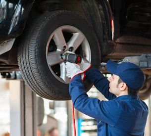 Brake Repair — Car Mechanic Replacing Wheel in Antioch, CA