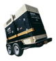 Black and beige Kohler generator on a trailer, angled, outdoors.